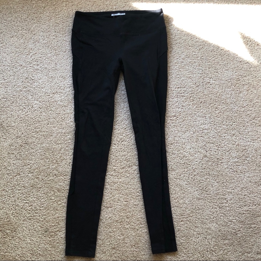 black workout leggings with a mesh side leg cutout